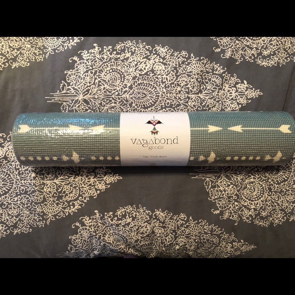 Vagabond holds yoga mat